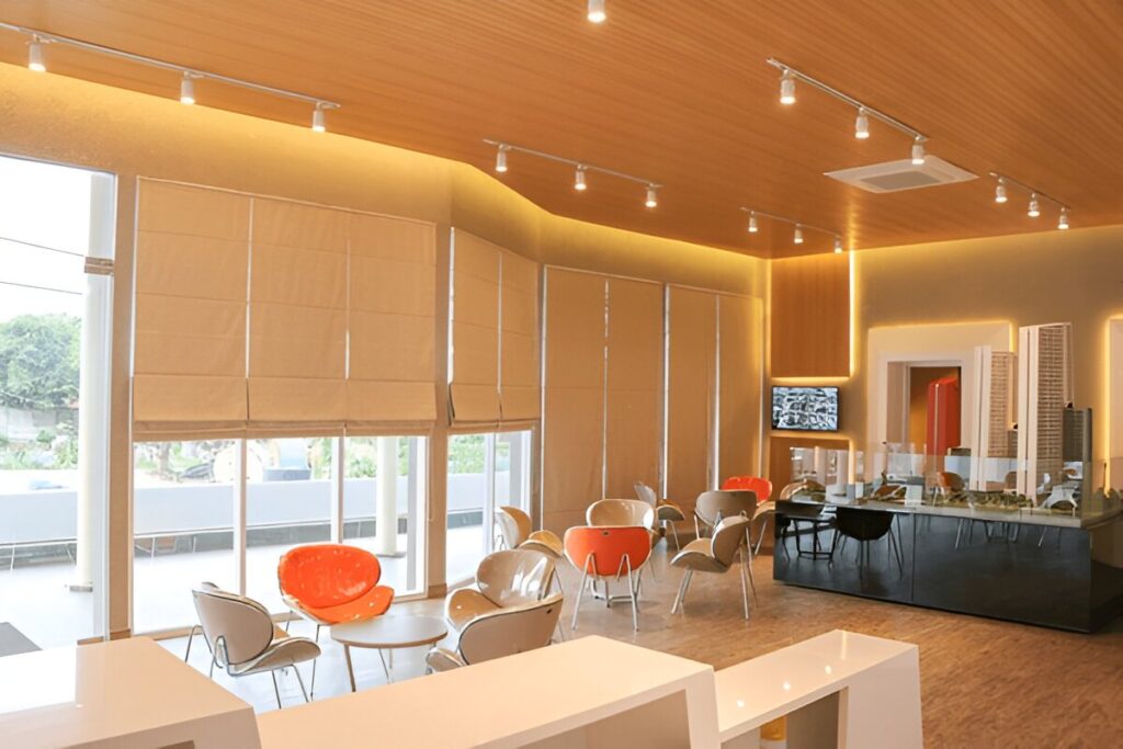 A modern café with floor-to-ceiling Roman blinds, showcasing their stylish and functional appeal in commercial settings.