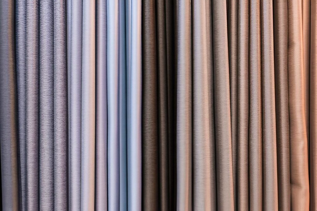 Variety of blackout curtain fabrics in different colours and textures, offering customization options for any space.