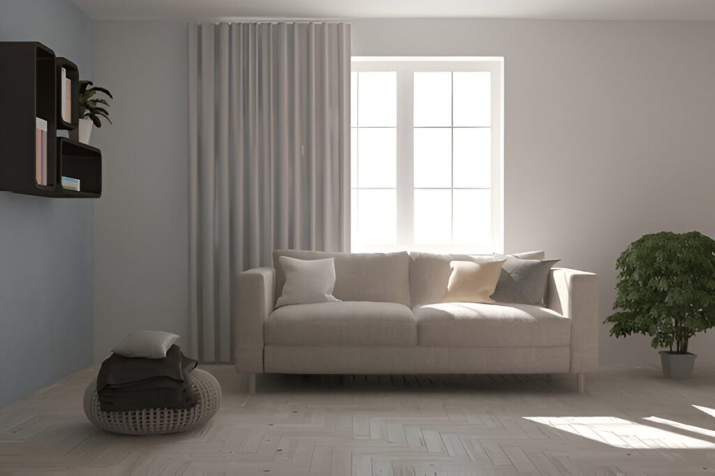 A minimalist living room in Dubai featuring a beige sofa, soft neutral decor, and premium Dubai blackout curtains filtering natural light for a cozy and stylish ambiance.
