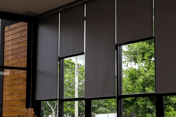 Stylish gray blackout blinds covering large glass windows, providing privacy and modern aesthetics for Dubai homes in 2025.