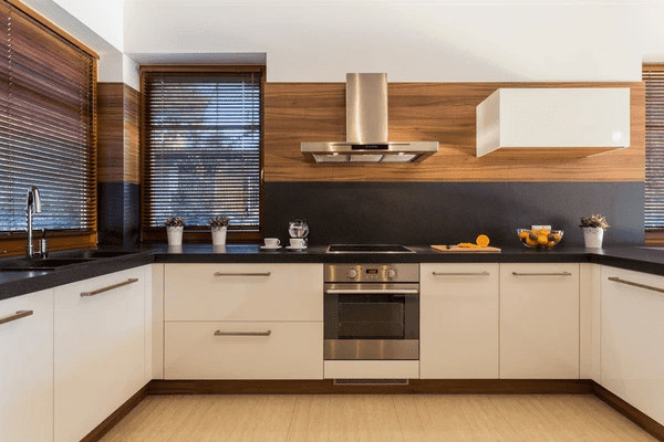 A stylish kitchen in Dubai featuring sleek cabinetry, stainless steel appliances, and wooden blinds. The roman blind 2025 best and cheap option enhances privacy and aesthetics.