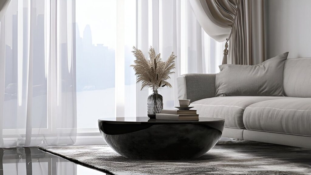 Elegant living space with sheer and Dubai blackout curtains, a modern black coffee table, and a cozy gray sofa.