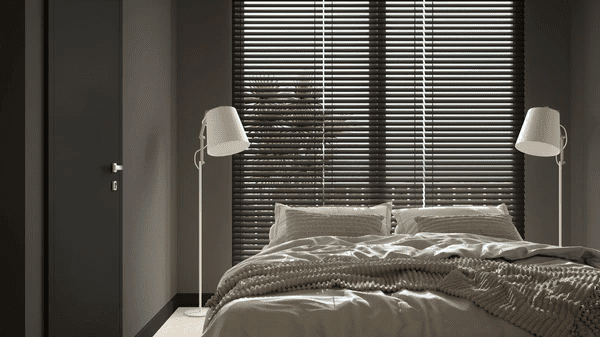A modern bedroom featuring dark Venetian blinds, adding sophistication and privacy to the space.