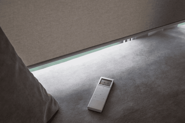  A white remote control panel for top-rated motorized blinds 2025, offering an affordable and cheap way to automate your window shades.