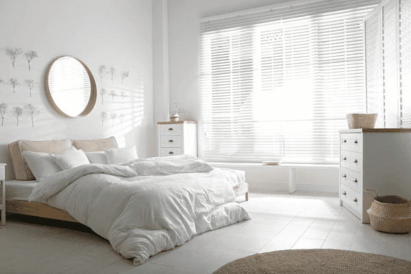  Elegant white Venetian blinds in a modern Dubai bedroom, offering trendy, affordable, and stylish privacy solutions for 2025 interior design trends.