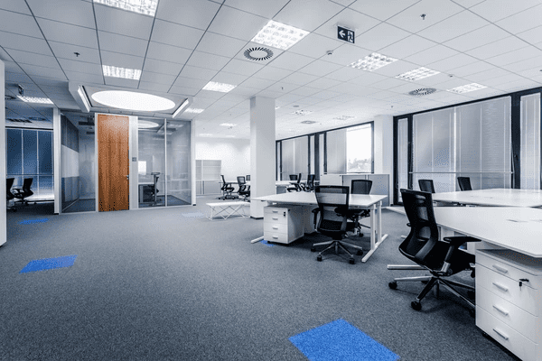 A sleek and modern open-plan office with high-quality window blinds, offering a professional and well-lit workspace.