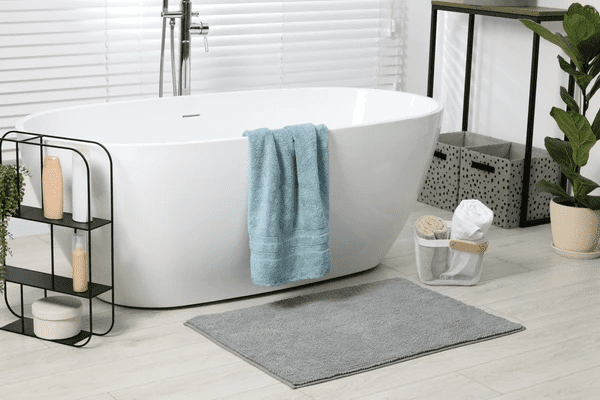 A sleek and modern bathroom featuring a freestanding bathtub, stylish window blinds, and elegant décor, showcasing the best affordable window blinds in Dubai for 2025.
