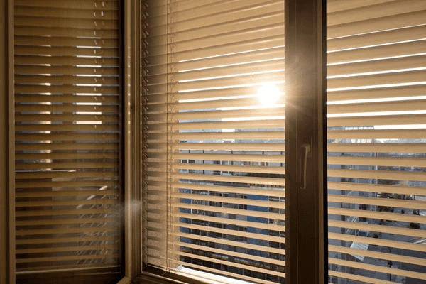 Sunlight filtering through modern window blinds in a Dubai high-rise, reducing glare and providing eye strain protection.