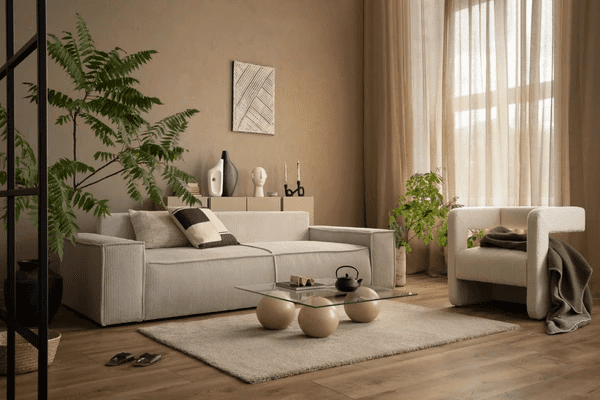 A beautifully designed modern living room featuring luxurious beige curtains, a sleek contemporary sofa, stylish décor, and lush greenery, creating a warm, elegant, and inviting ambiance.