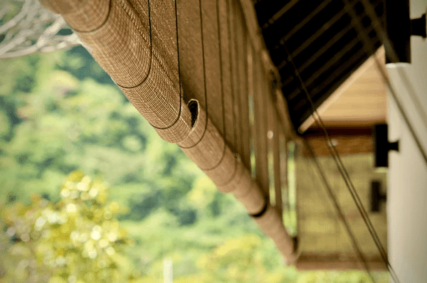 Sustainable bamboo blinds installed in a modern outdoor setting, offering an eco-friendly and recyclable window treatment solution for energy efficiency and natural aesthetics.
