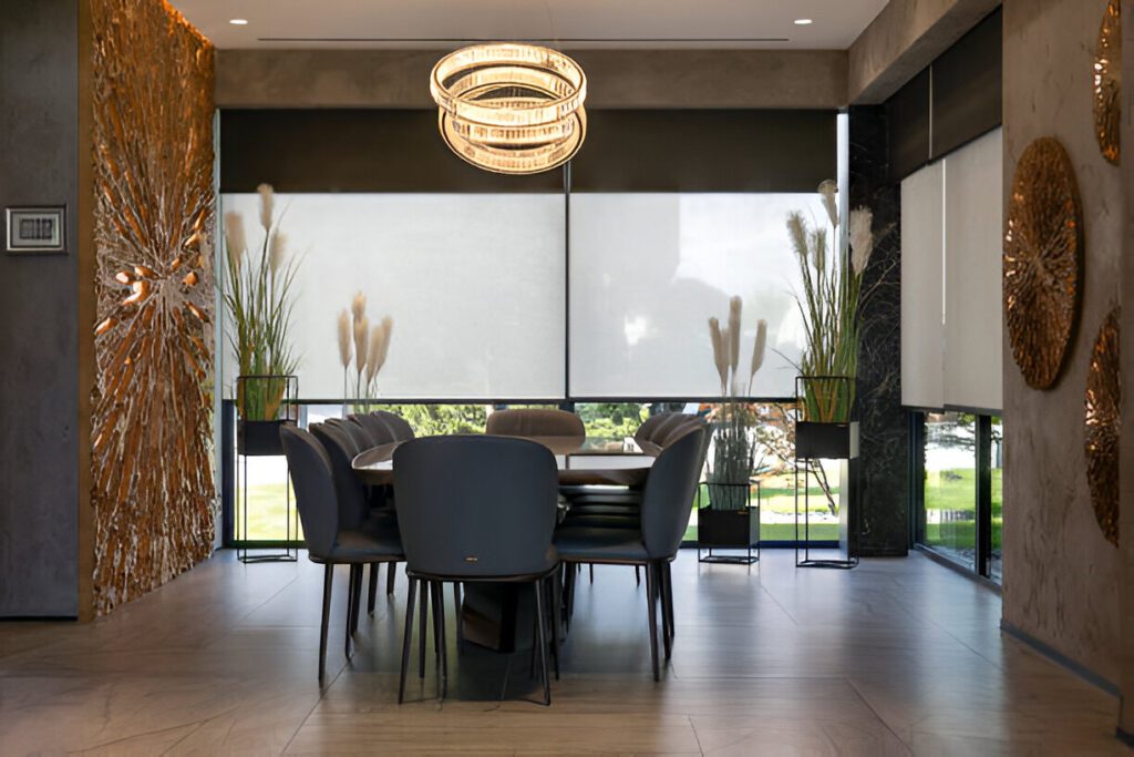 Elegant motorized roller blinds in a luxurious Dubai dining space, blending traditional Emirati aesthetics with modern smart home convenience.