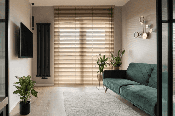 A modern living room with Dubai Blinds 2025 soundproof wooden blinds, offering the best quality light control, privacy, and elegance.
