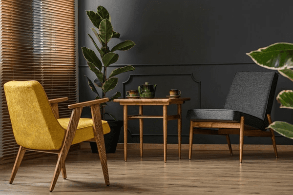 A stylish interior featuring wooden blinds, a dark accent wall, mid-century modern furniture, and lush green plants, creating a warm and elegant atmosphere.
