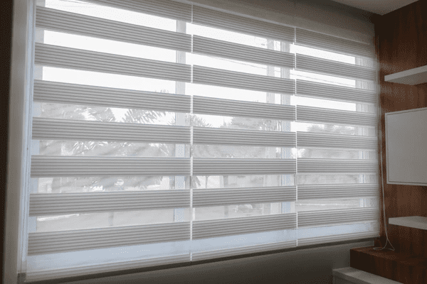 Modern zebra blinds with alternating sheer and opaque layers, providing stylish light control in a contemporary space.