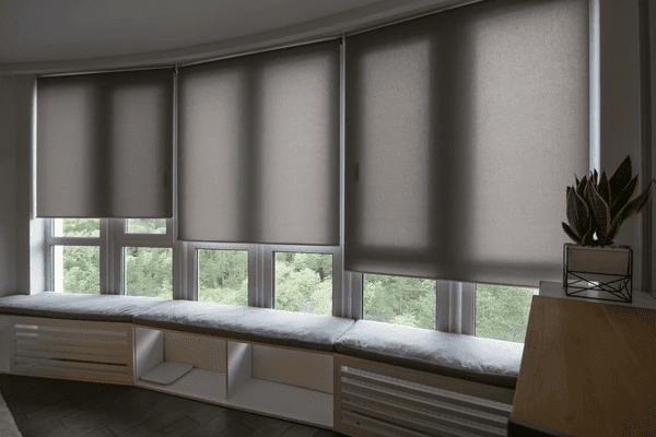 A modern interior featuring motorized roller blinds in Dubai, offering privacy, energy savings, and smart home convenience.