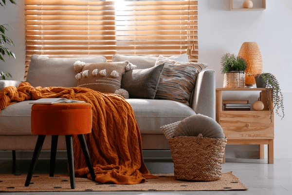 A cozy and stylish living room with Dubai Blinds 2025 soundproof, offering a blend of privacy, warmth, and modern aesthetics with the best quality wooden blinds.