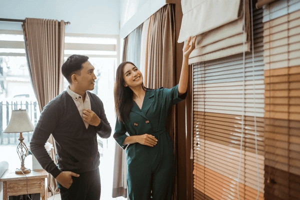 A satisfied customer exploring high-quality Roman blinds 2025 at Emirati Blinds & Curtains Shop in Dubai, known for its top-notch customer service and wide variety.