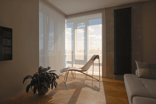 Elegant living space with soft fabric window roller blinds, allowing filtered sunlight while maintaining privacy, complemented by a stylish lounge chair and natural wood flooring.