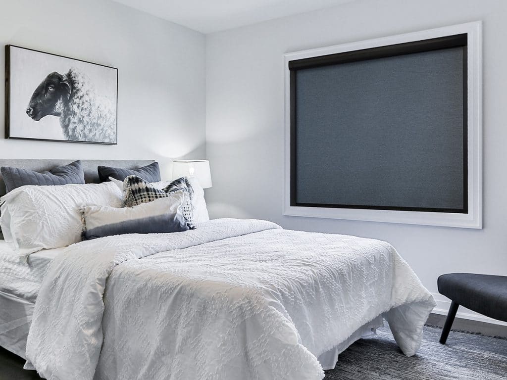 Modern bedroom featuring blackout roller blinds 2025 best and cheap in Dubai, ensuring complete darkness for a restful and undisturbed sleep.

