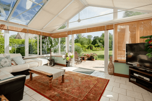Bright conservatory with modern bamboo blinds, showcasing the best blinds for conservatories in 2025—sleek, elegant, and perfect for cozy, stylish homes.