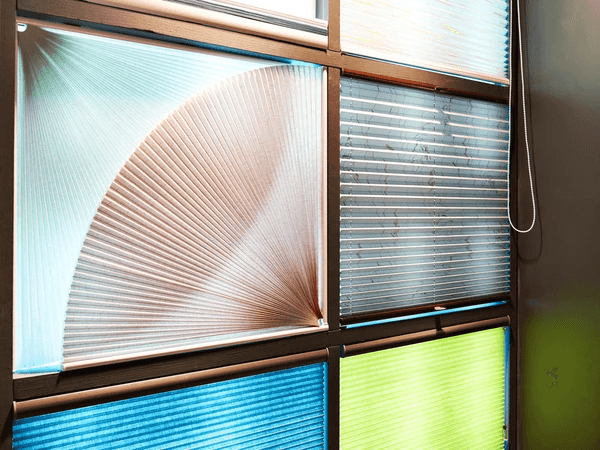 Colorful and modern window blinds with sleek textures and patterns on display in a Dubai store.