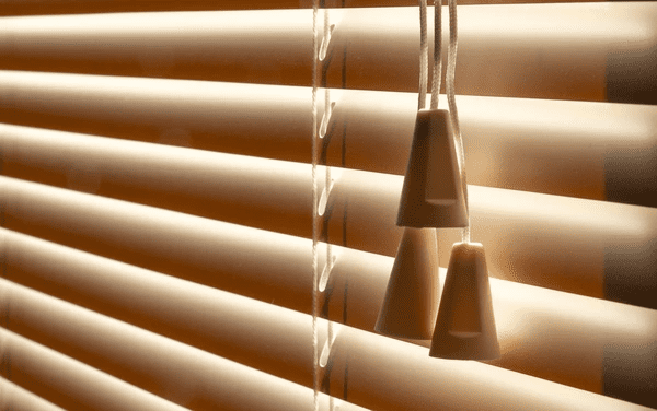 Close-up of cord blinds with sunlight filtering through in a cozy, modern interior in Dubai 2025.