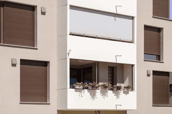Modern balcony with stylish outdoor roller blinds, ideal for cozy homes in Dubai, featuring top-rated sleek and luxurious designs.