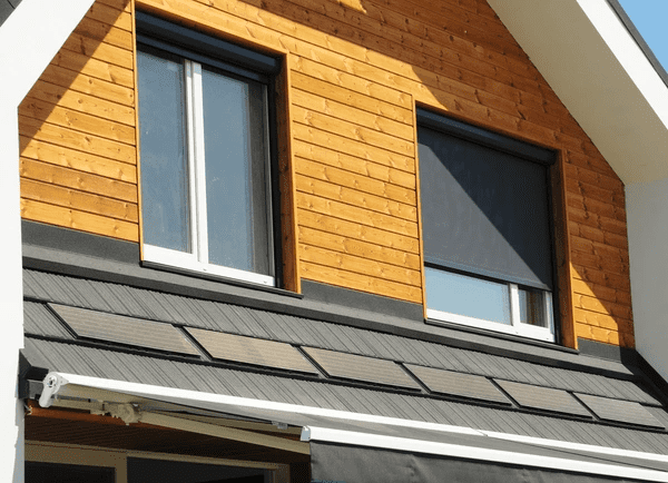 Sleek and modern outdoor blinds installed on a contemporary wooden and white house exterior in Dubai, showcasing 2025’s top-rated luxurious home trends.