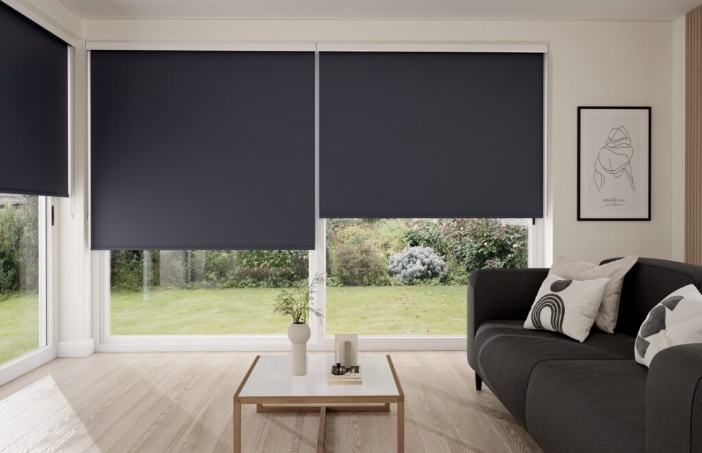  Cozy living room with large patio doors featuring dark grey roller blinds and modern minimalist decor.