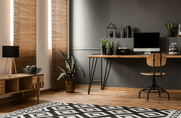  A stylish home office with wooden blinds, a sleek desk setup, and elegant decor in Dubai.