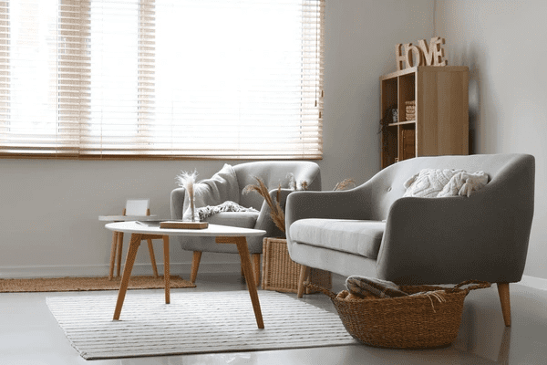 Modern cozy living room with grey furniture and sleek soundproof blinds, perfect for luxurious homes in Dubai 2025.