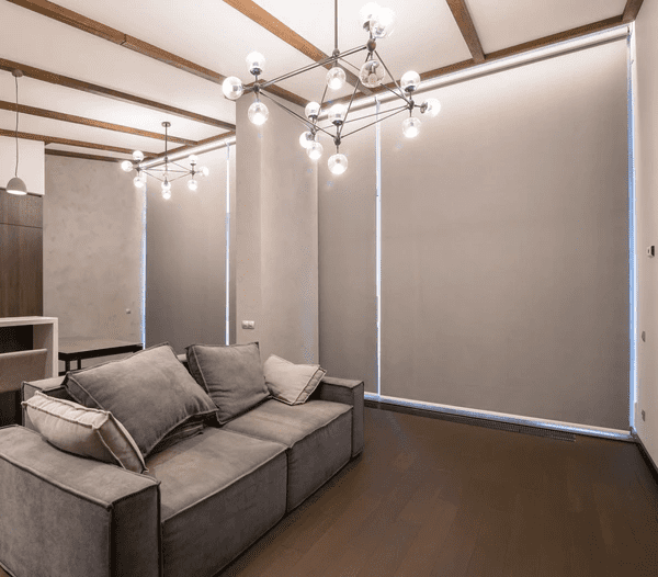 A stylish living room in Dubai with blackout motorized blinds fully closed, creating a cozy and elegant atmosphere.