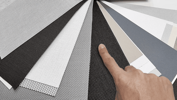 Hand selecting high-quality modern fabrics for luxurious and elegant blinds in Dubai 2025.