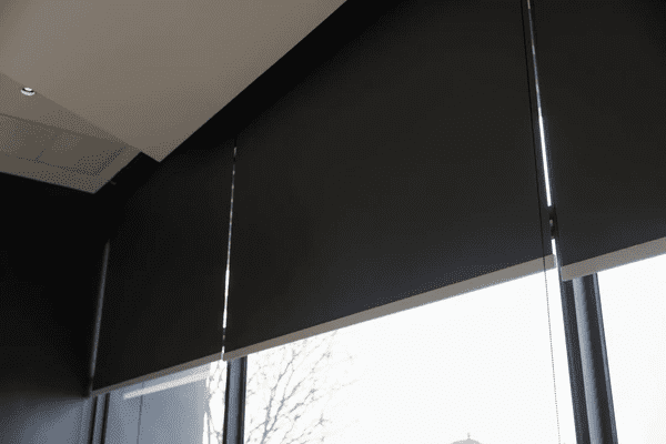 Close-up view of stylish black blackout blinds covering large windows, offering a sleek and modern design for contemporary Dubai homes.