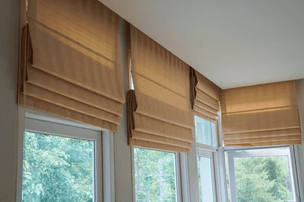 Best Roman Blinds in Dubai 2025 - Warm beige roman blinds elegantly covering large windows, blending luxury with modern style.
