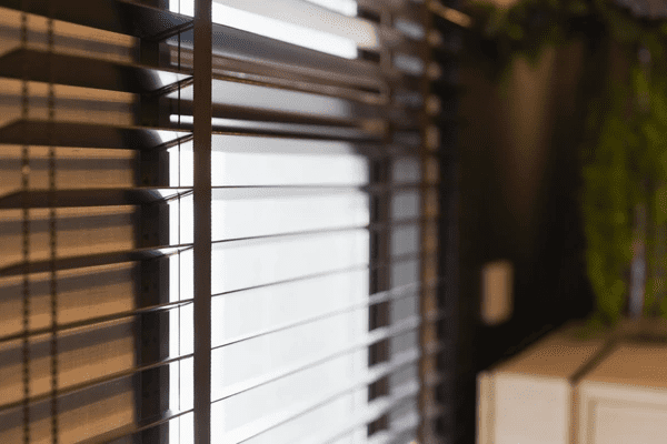 Close-up of modern capital improvement grade blinds in a contemporary Dubai home, filtering soft daylight indoors.