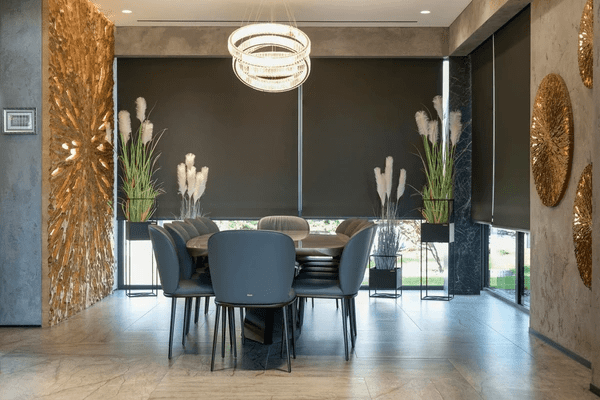 Elegant dining room with sleek black certified capital improvement grade roller blinds in Dubai 2025