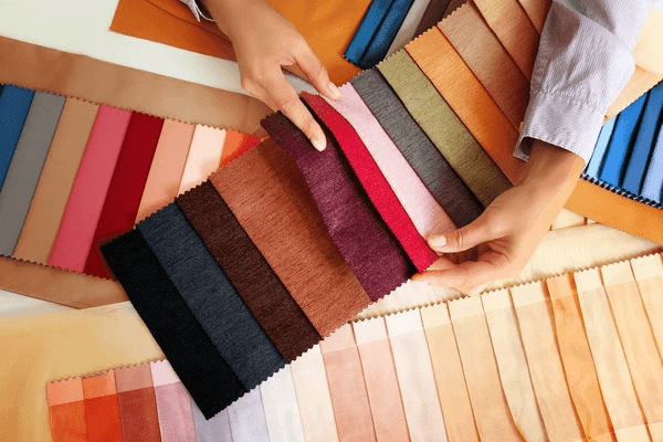 Customer selecting fabrics for heat-insulation curtains, showcasing a wide range of stylish and functional options.