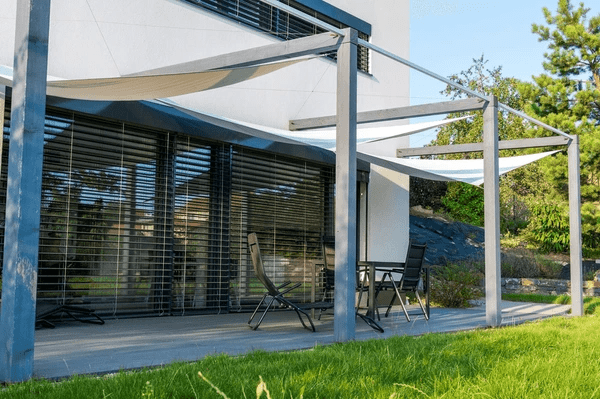 Stylish furnished rental home in Dubai with sleek outdoor blinds, elegant patio furniture, and modern architecture.