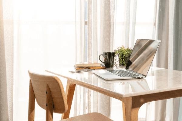 Modern home office with heat-insulation curtains, creating a comfortable and stylish workspace.