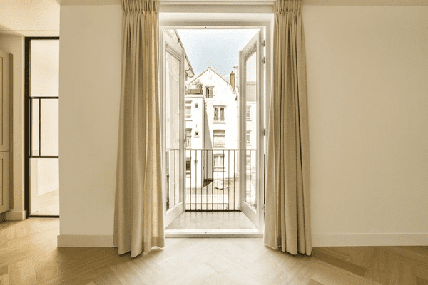 Modern apartment with heat-resistant curtains that offer both style and superior insulation.