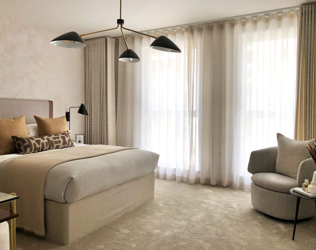 Motorized wave curtains in a cozy bedroom, offering a sleek and modern design with automated functionality, ideal for Dubai homes in 2025.