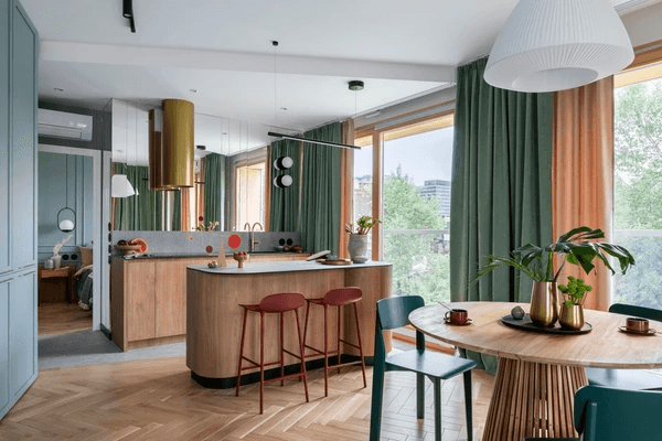 Stylish open-concept urban apartment with a dining area, kitchen island, and floor-to-ceiling noise reducing curtains in green and orange.