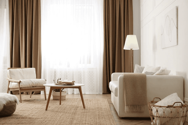 A luxurious and modern living room featuring the top-rated shrink-proof curtains in Dubai. The curtains offer a sleek and trendy design perfect for any cozy home.