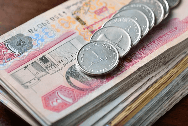 UAE dirham coins and notes stacked neatly, symbolizing investment in best expensive curtains in Dubai 2025 – top rated, luxurious, modern, and cozy
