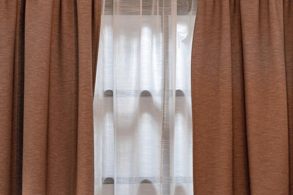 Brown double-layer blackout curtains with sheer inner lining, designed for modern summer homes in Dubai 2025.