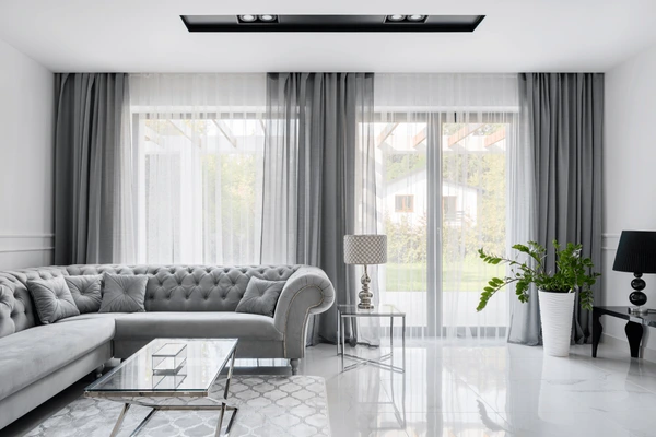 Elegant villa living room in Dubai with sleek gray Emirati Blinds & Curtains, creating a luxurious modern interior design.