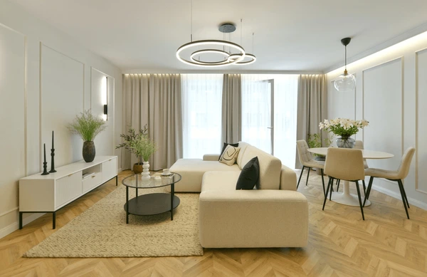 Elegant living room in Dubai with sleek falling curtains in neutral tones, creating a modern, trendy, and cozy atmosphere.