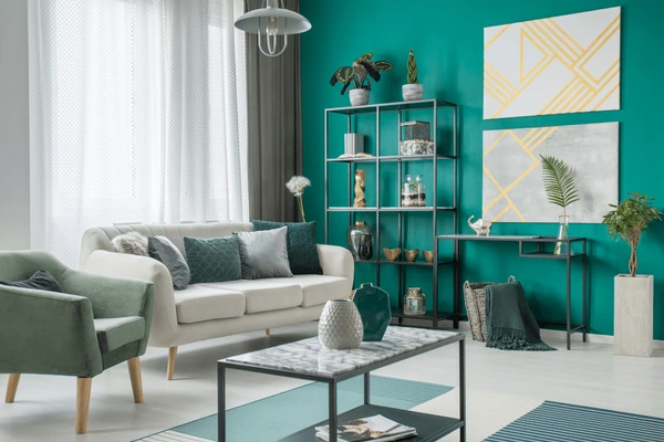 Stylish living room with teal green walls, modern curtains, and cozy contemporary furniture in Dubai 2025.