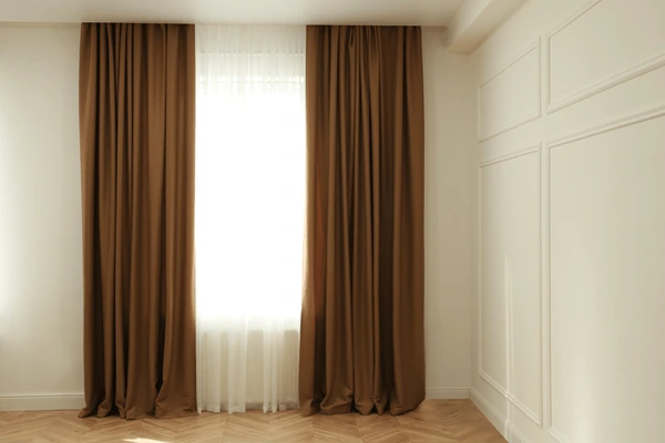 Normal sized short brown curtains in Dubai 2025 with white sheer panels, modern minimalist design, and elegant cozy style.